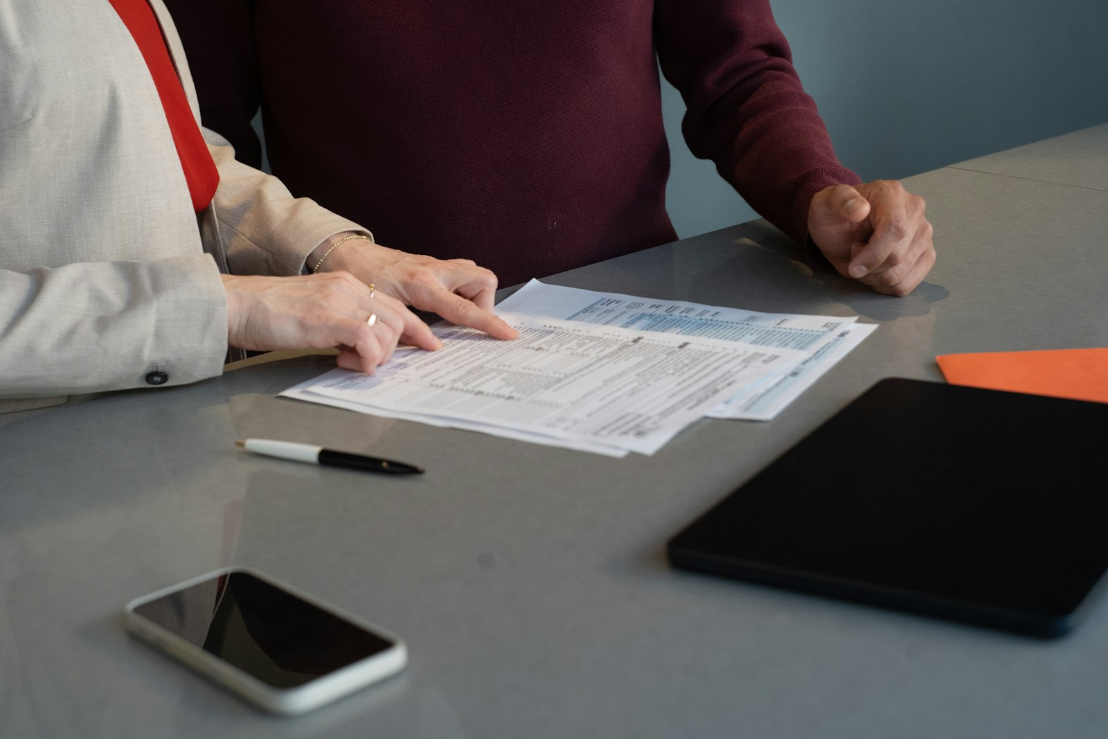Two people going through admission paperwork at a desk
