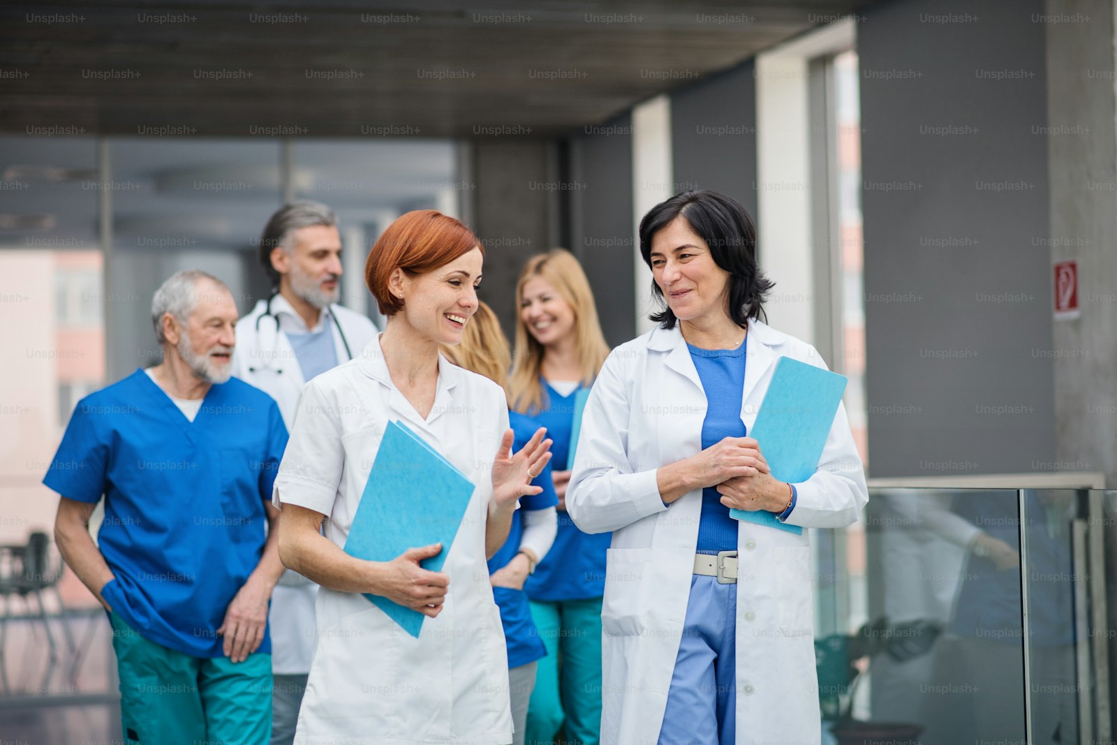 Doctors walking and talking along a hospital corridor