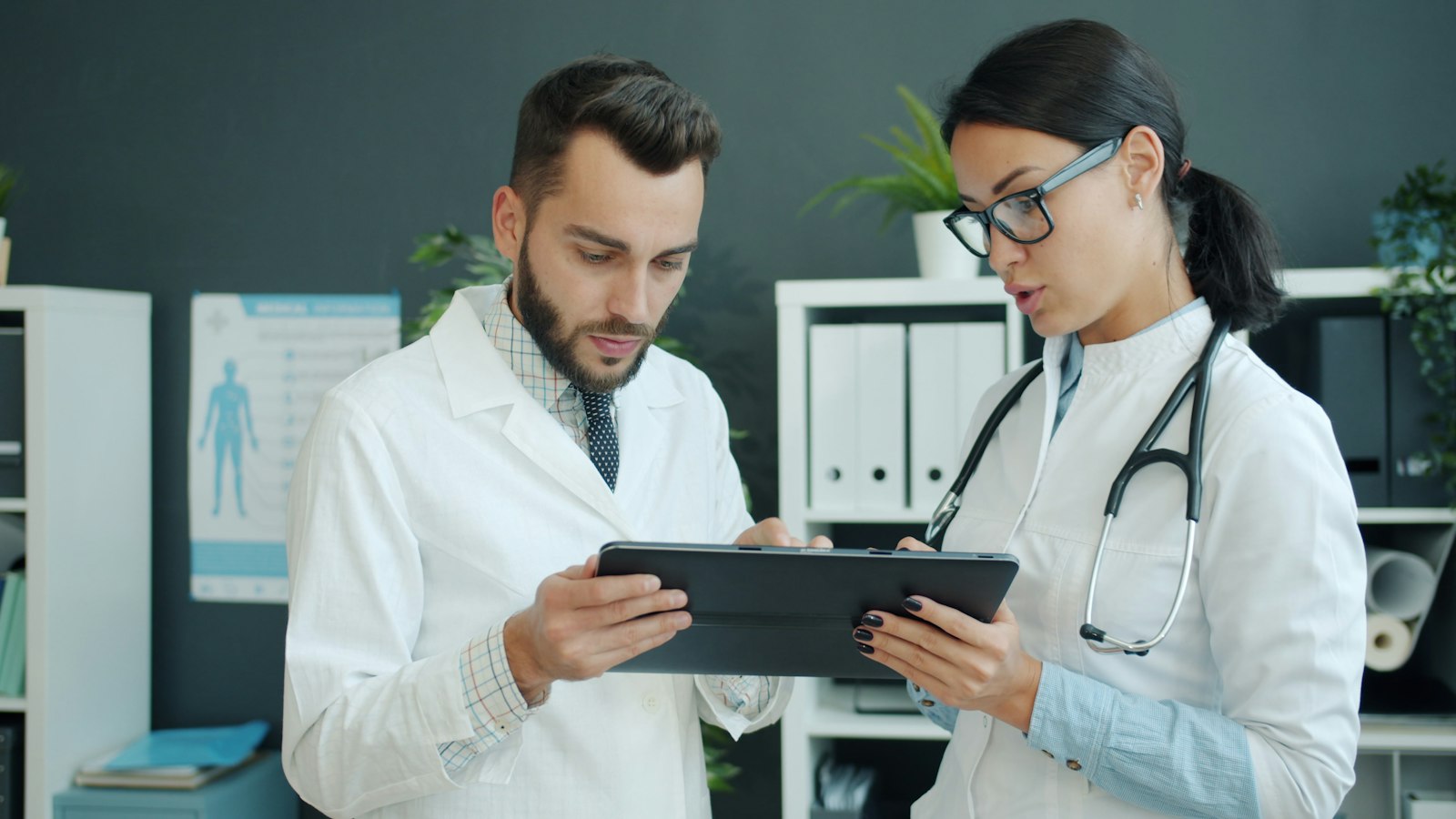 Two doctors reviewing a case together on a tablet