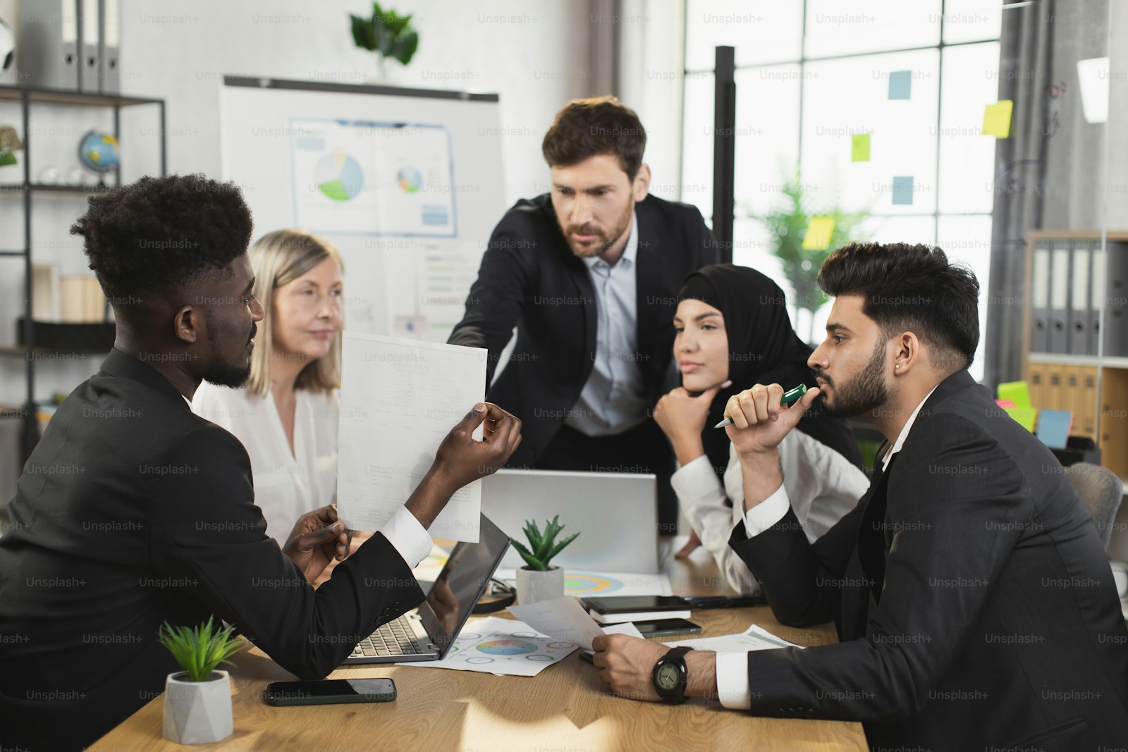 Colleagues reviewing benefit documents in a bright office meeting
