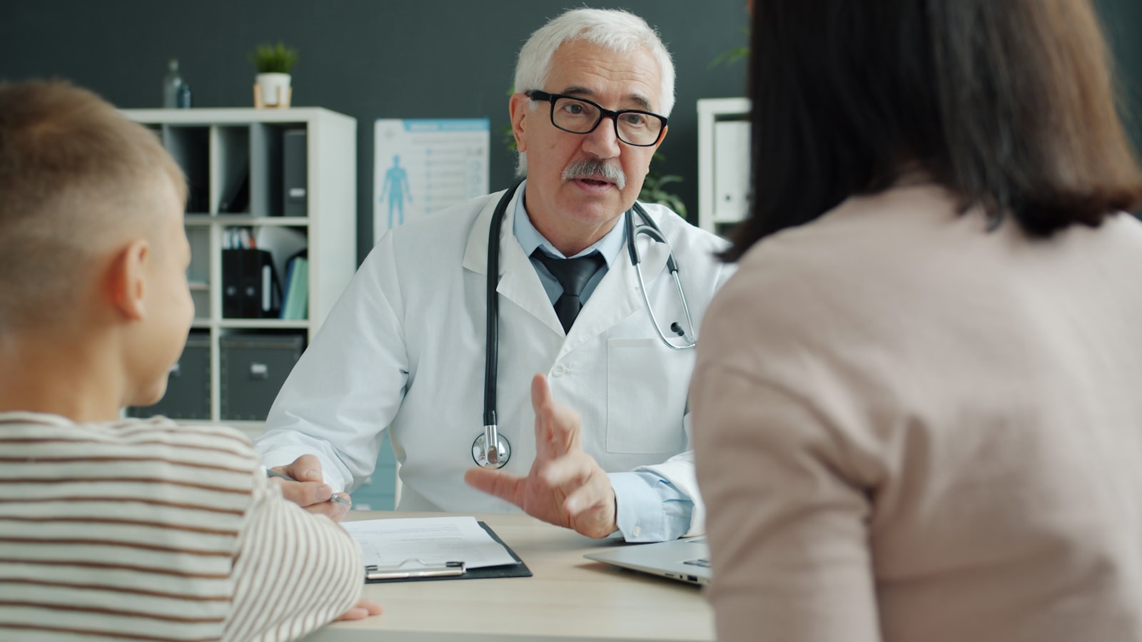A doctor consulting with a mother and her child