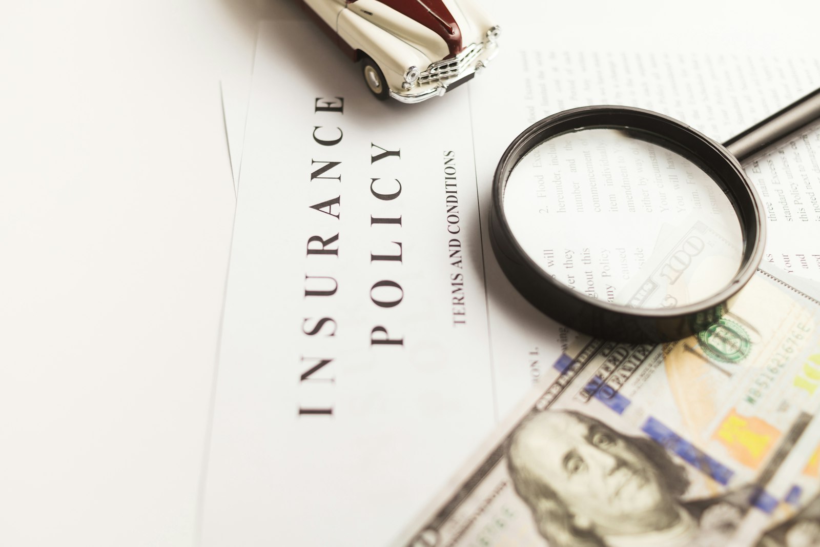 A magnifying glass resting on the small print of a document