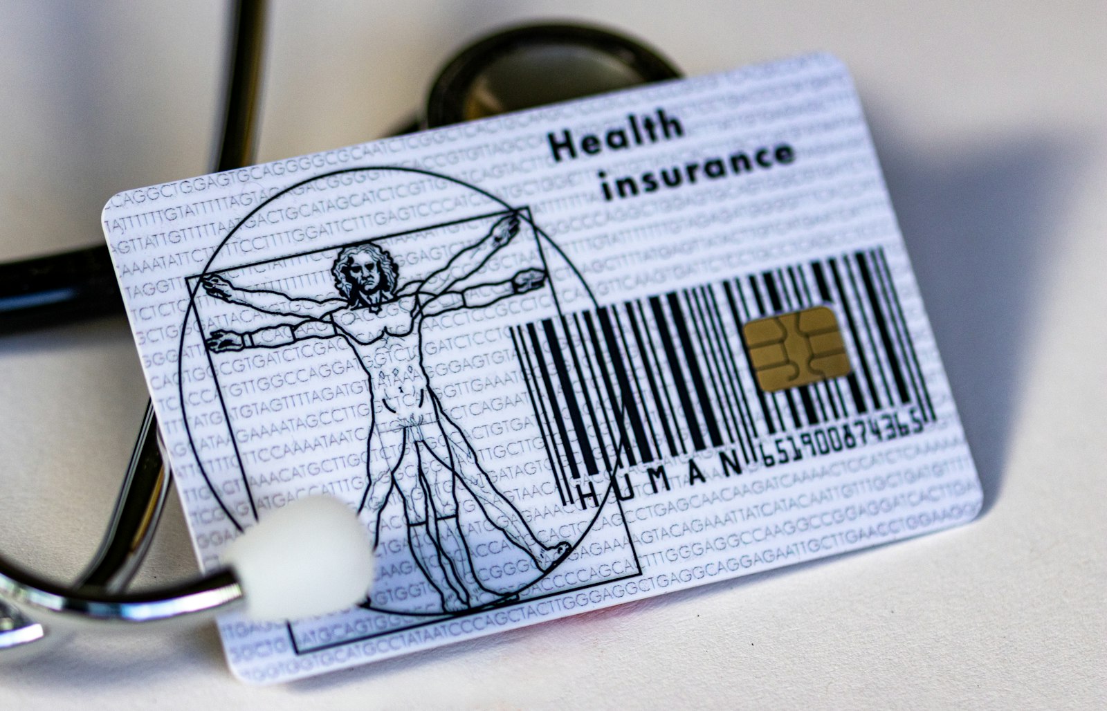 A health insurance membership card beside a stethoscope