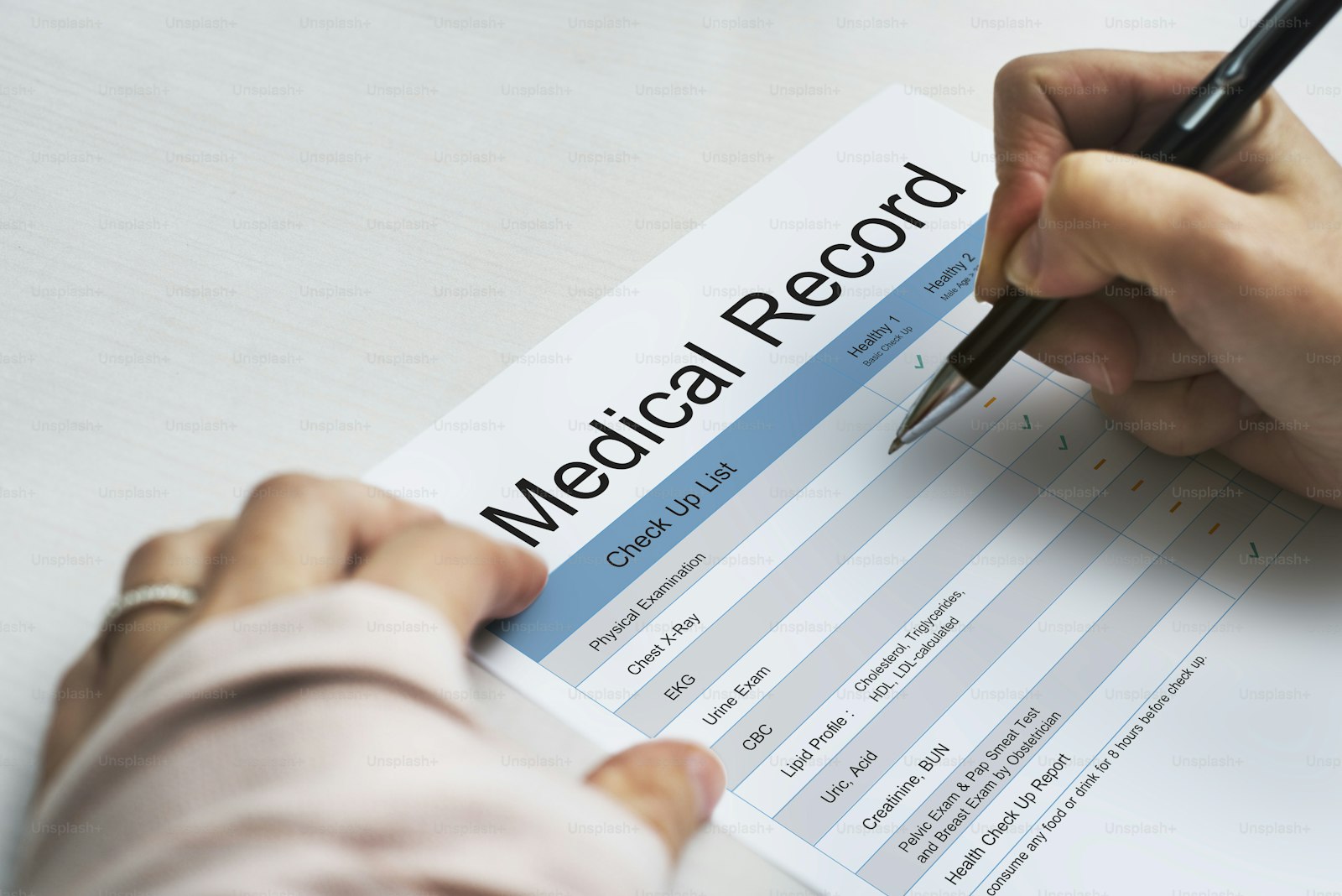 A patient completing a medical history form by hand
