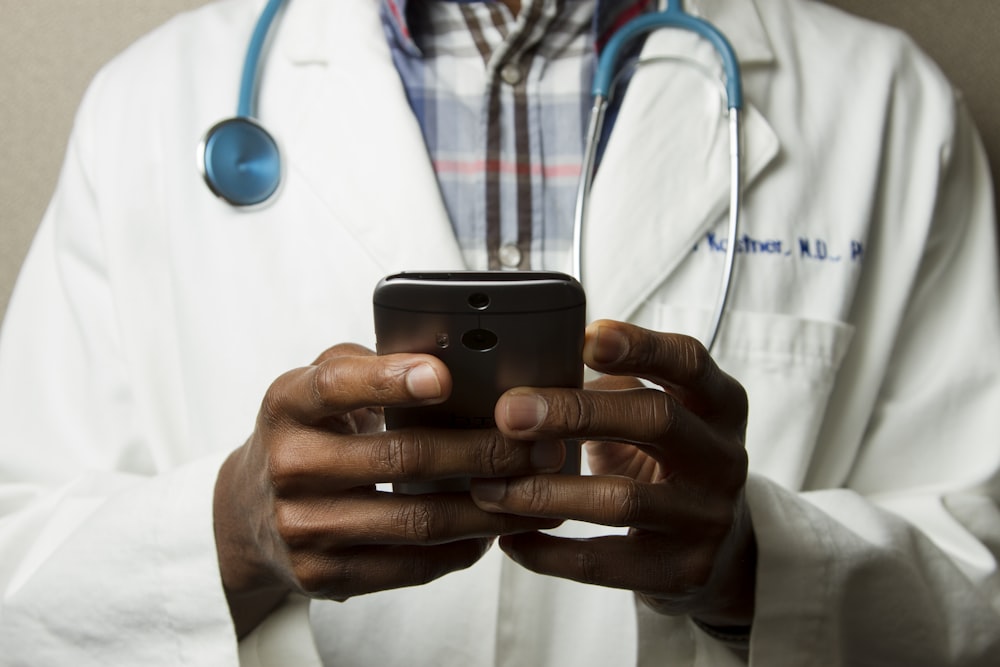 A doctor reviewing notes during a consultation