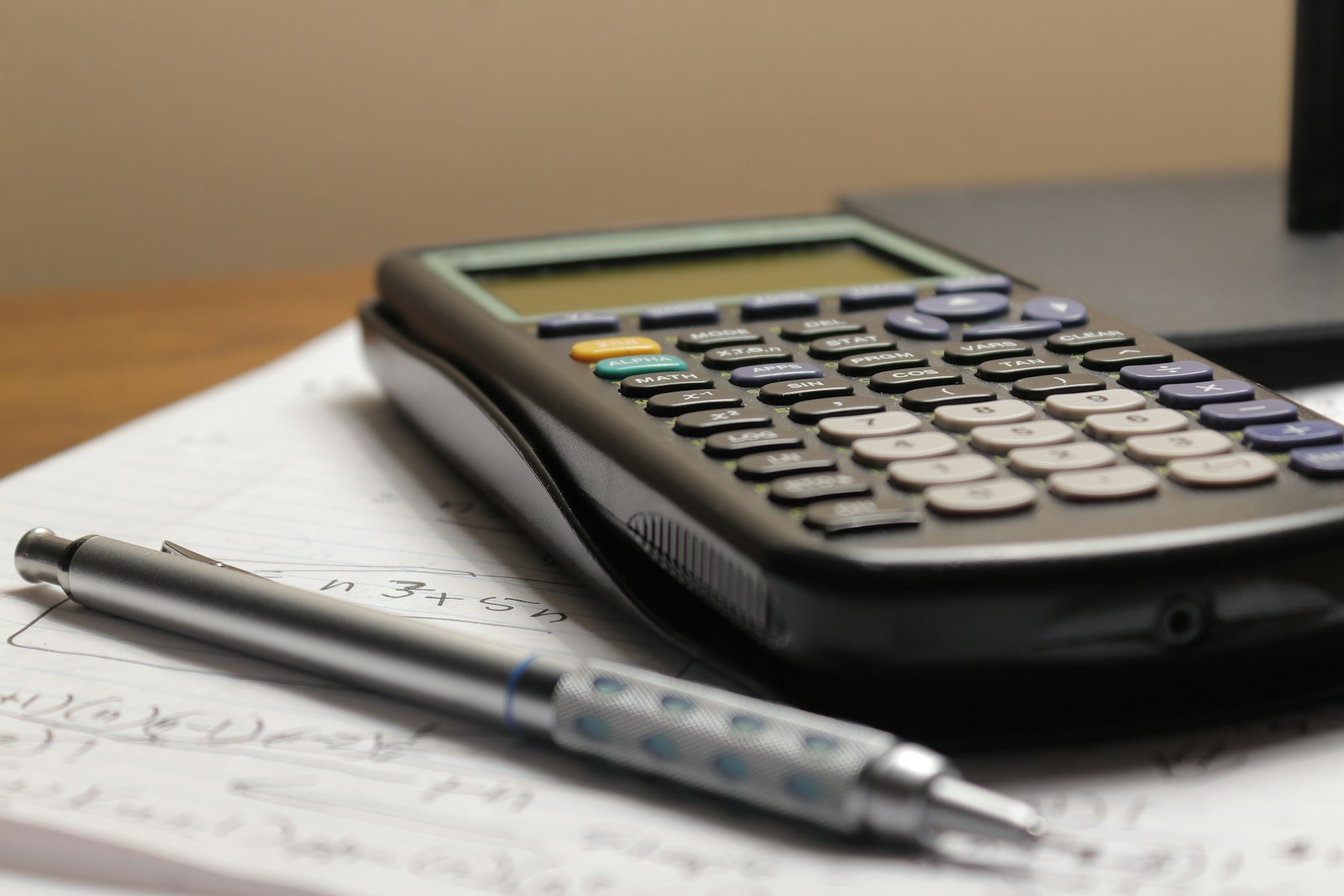 A calculator and pen on a printed quotation
