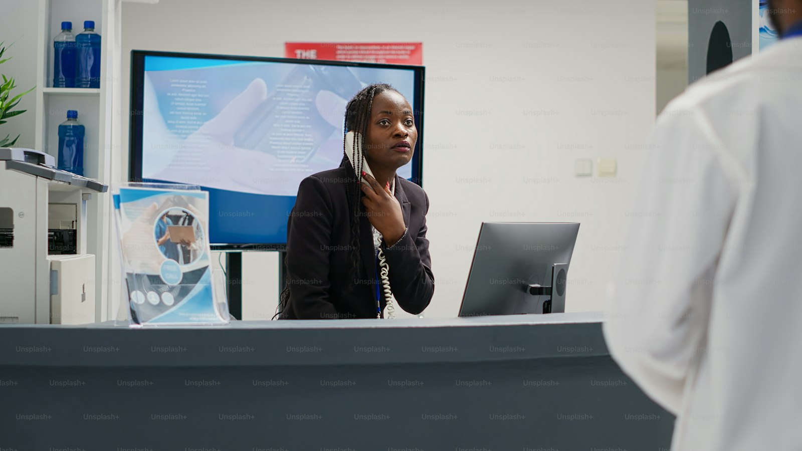 A receptionist taking a call at the front desk