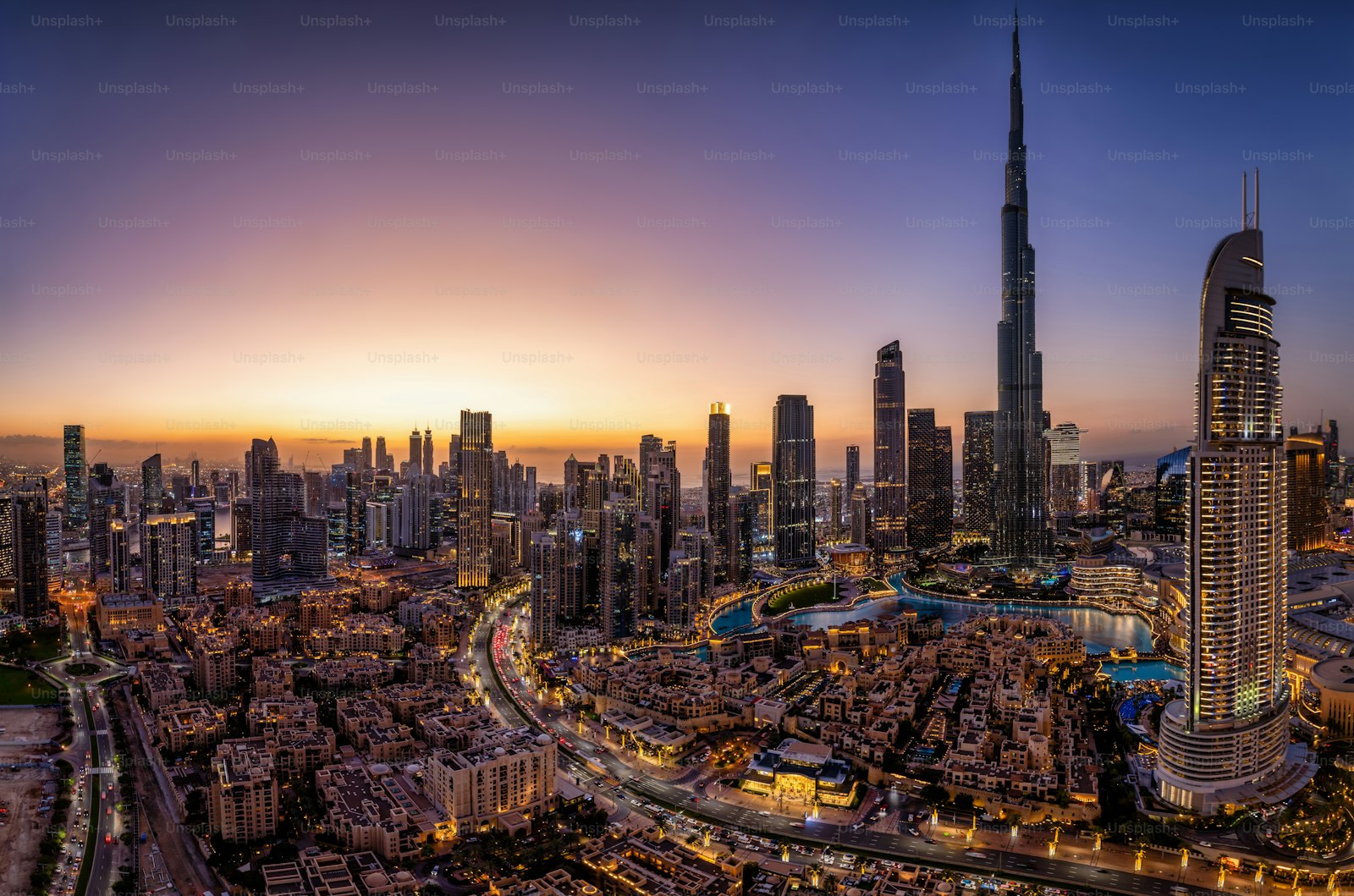 The illuminated Downtown Dubai skyline at dusk