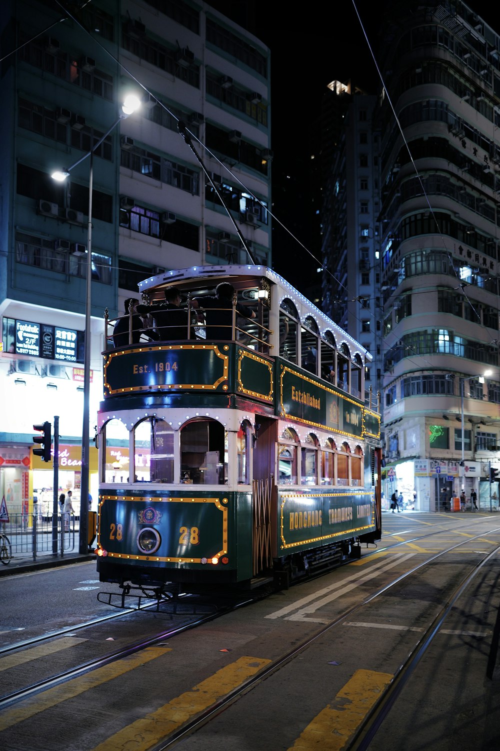 Classic double-decker tram on a Hong Kong street at night