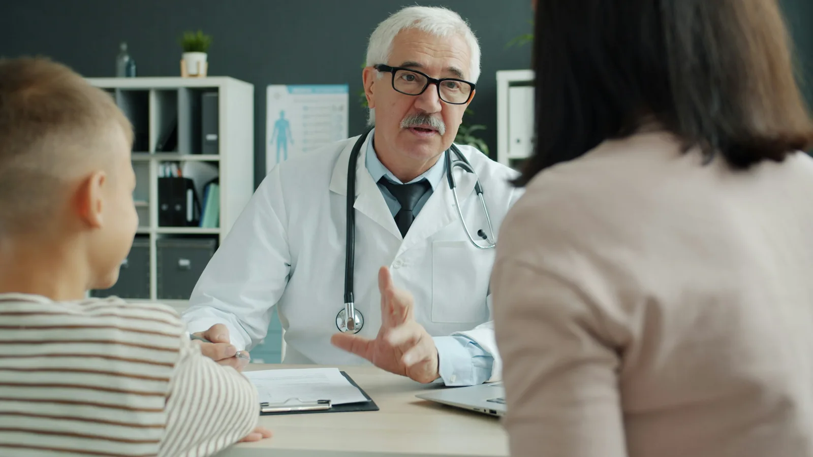 A doctor speaking with a mother and child; illustrative healthcare photograph, not ExpatMedicare staff