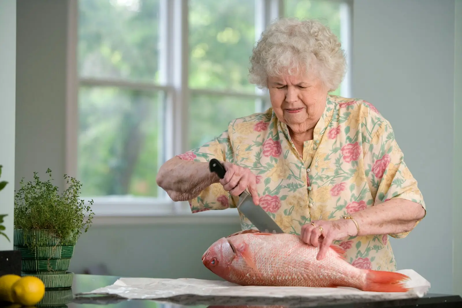 A senior woman preparing a meal at home